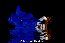 Redhead model underwater in a swimming pool by Michael Baukloh 